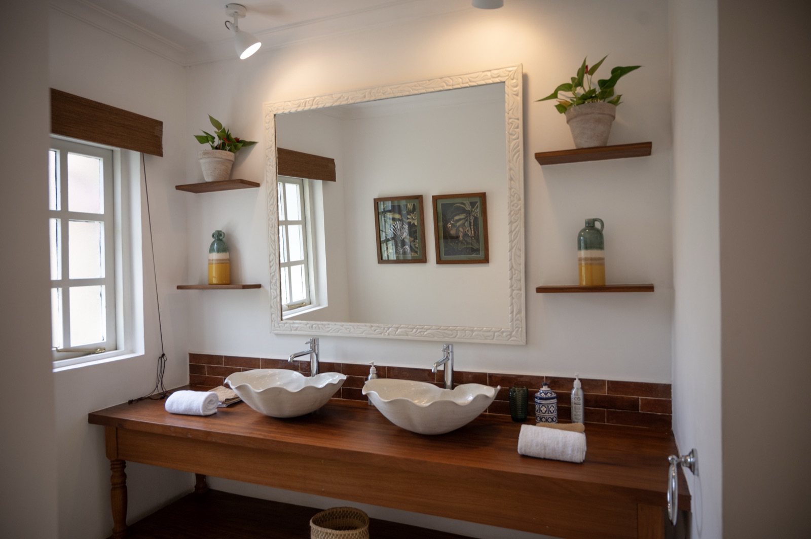 The en-suite bathroom in the Acacia room, with twin stone basins on a wooden vanity