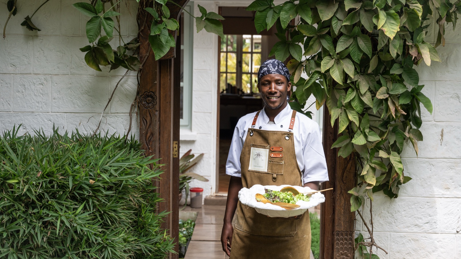 A dish being carried out through the garden